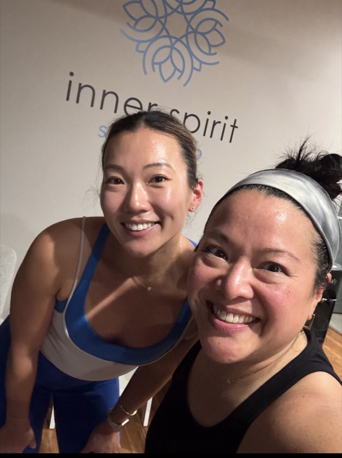 Two teachers smiling together in the studio.